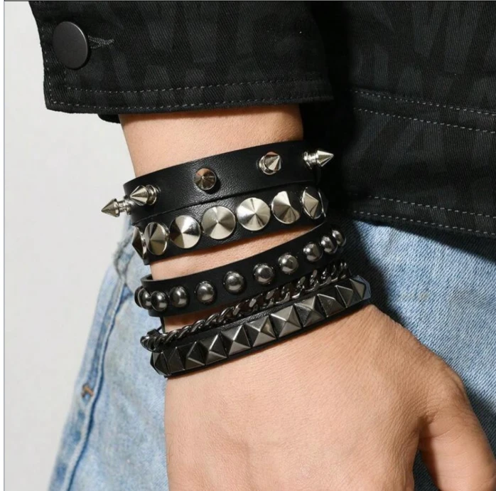 Stacked black leather bracelets with silver studs and spikes