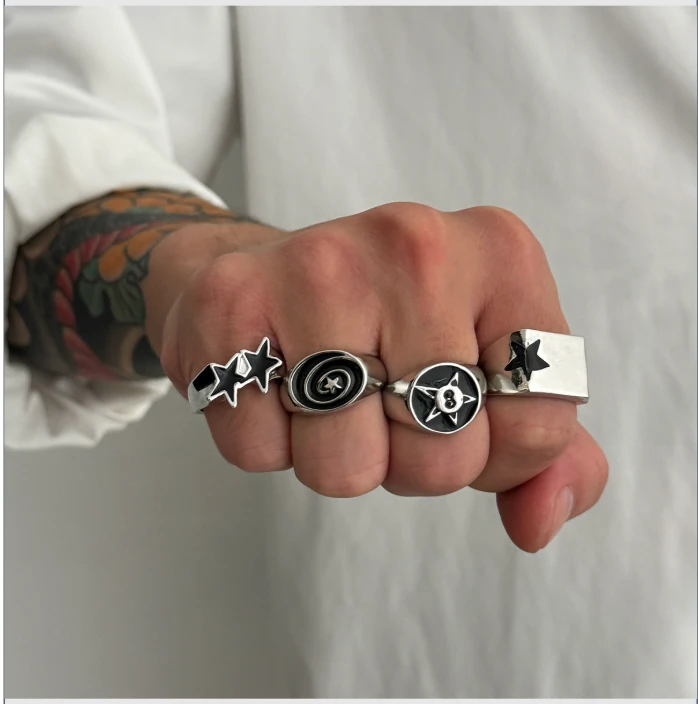 Silver signet rings with black enamel star designs